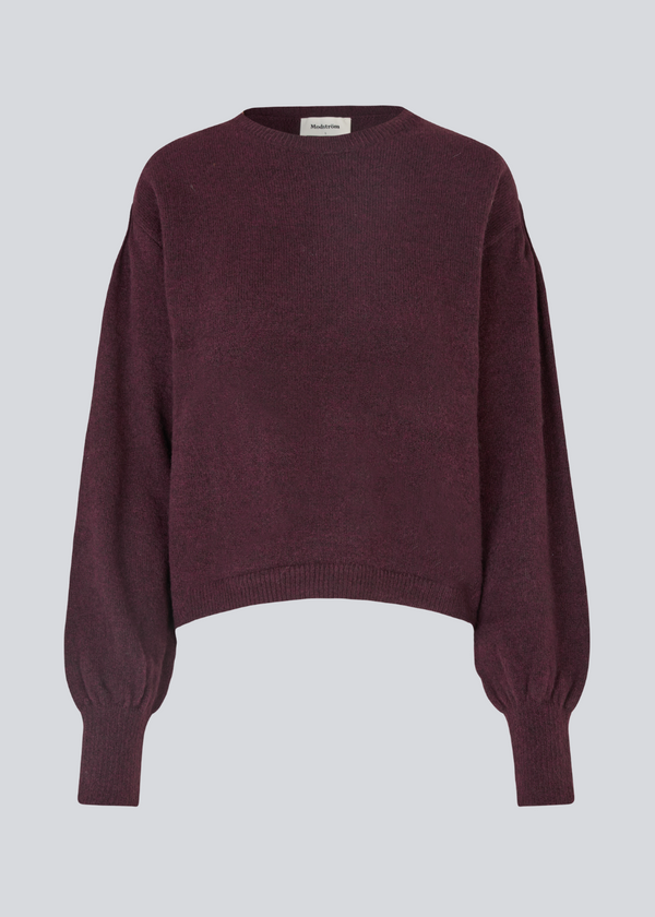 Red soft knit with loose sleeves. Patrickmd O-neck has a round neckline and ribbed hem.