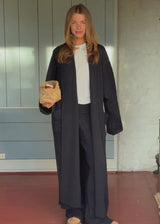 Blue cable-knit long cardigan. The Josefinemd robe is a long cardigan featuring pockets and a tie belt. Perfect for cozy mornings and chilly winter days.&nbsp;Josefine Vogt (165 cm) and the model (177 cm) are both wearing size Small.