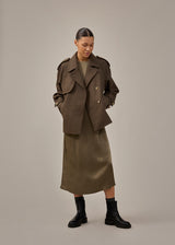 Cropped double-breasted wool coat in a brown color with hidden buttons. EsmundMD jacket has classic coat details with raglan sleeves and an high yoke at the back. Lined. The model is 175 cm and wears a size S/36.