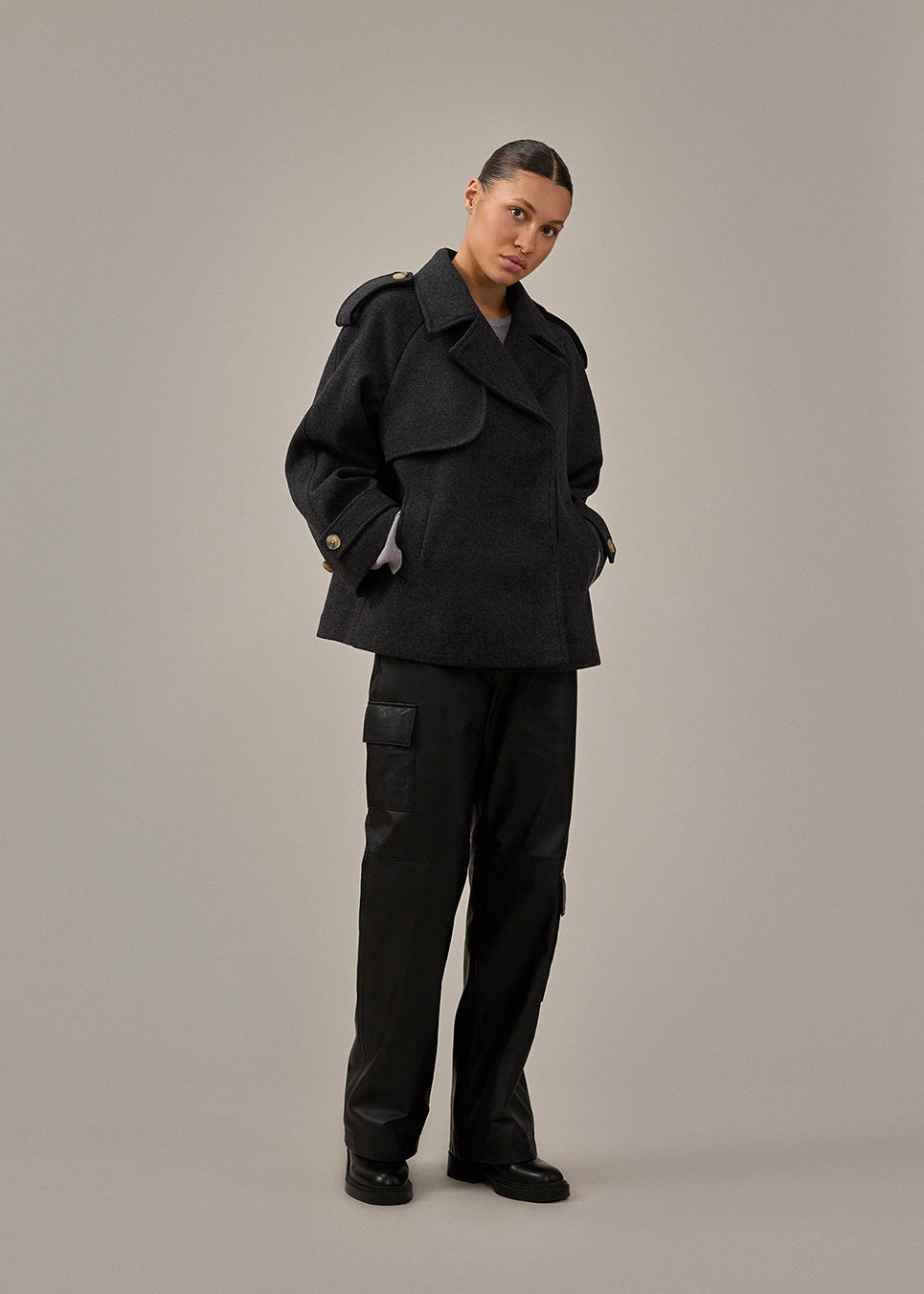 Double-breasted black wool coat with hidden buttons. EsmundMD jacket has classic coat details with raglan sleeves and a high yoke at the back.