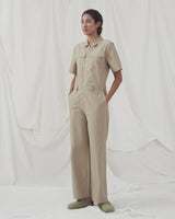 Jumpsuit in a crispy cotton blend with long, wide legs. DedeMD jumpsuit has short sleeves, collar, and zipper down the front. Belt straps at the waist. The model is 177 cm and wears a size S/36.
