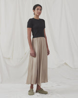 Long beige skirt with wide skirt. DevanMD skirt is designed in a shiny satin material with elasticated medium waist. The model is 177 cm and wears a size S/36.¨