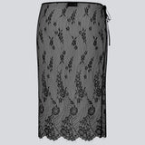 A square, sheer lace scarf worn as a wrap skirt. The Taffymd waist scarf ties at the side and is styled over trousers as part of the layered look trend.