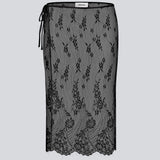 A square, sheer lace scarf worn as a wrap skirt. The Taffymd waist scarf ties at the side and is styled over trousers as part of the layered look trend.