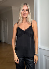 Satin top with a soft drape in black with black lace. TenjaMD top is detailed with lacing on the front and has thin straps.