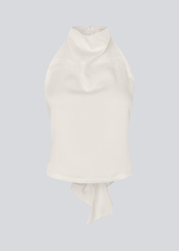 Halternecktop with a tiedetail in satin. Timmiemd top has an open back and a button closure at the neck.&nbsp;