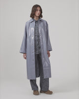Oversized coat in a shiny material. CharlesMD coat features a collar, push buttons, and long wide sleeves.