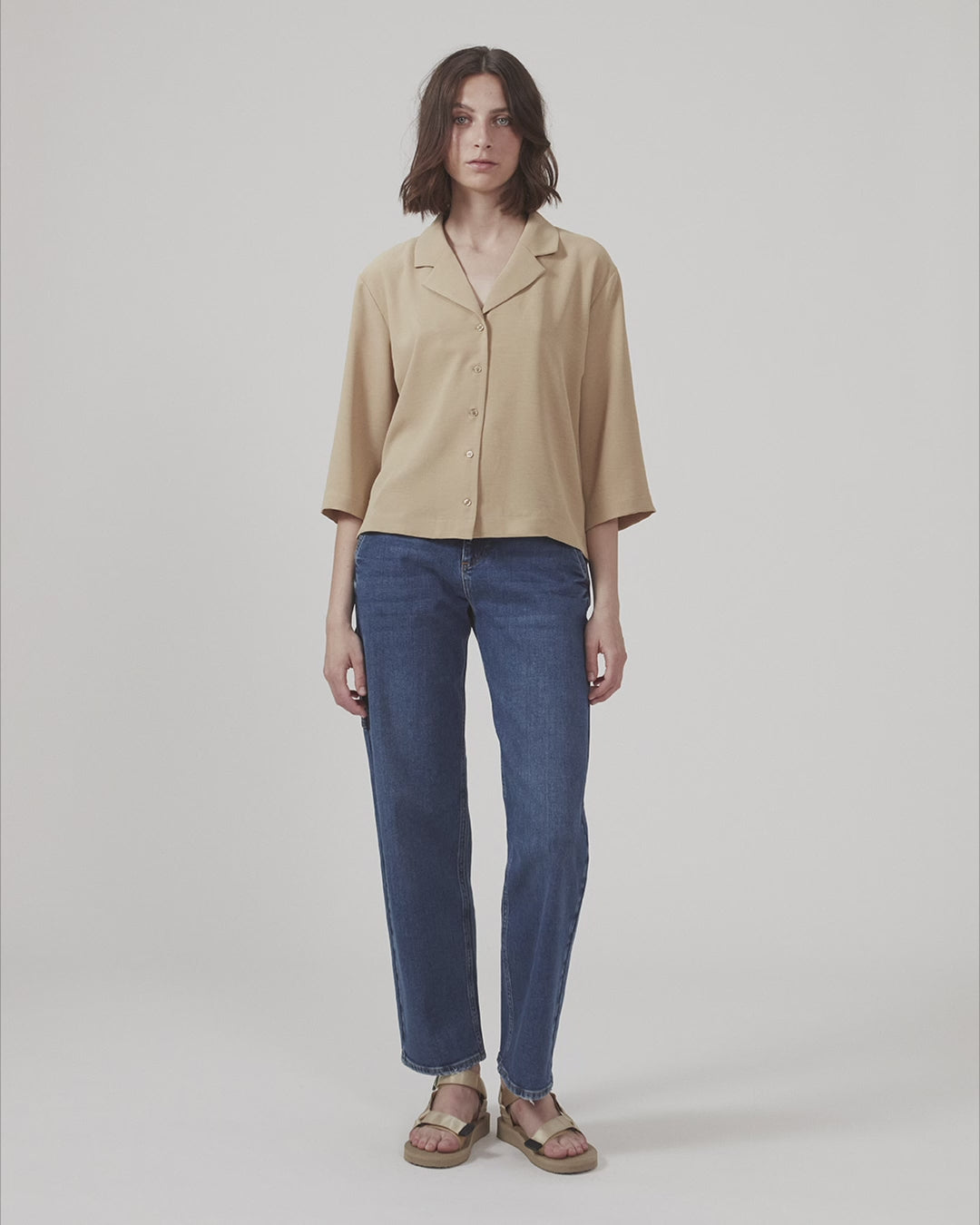 Shirt in beige in a relaxed silhouette and 3/4 length sleeves. AaliyahMD shirt has a resort collar, dropped shoulders and button closure in front.