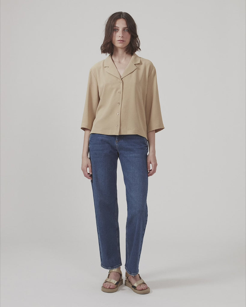 Shirt in beige in a relaxed silhouette and 3/4 length sleeves. AaliyahMD shirt has a resort collar, dropped shoulders and button closure in front.