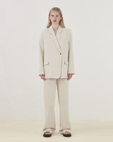 Blazer in a voluminous fit with an asymmetrical look. Park blazer in Cream Milk is made from an airy linen quality, which is easy to style with the matching pants or over a dress on a summer evening.