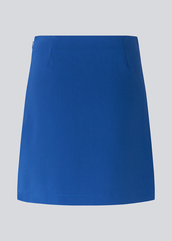 Classic A-line skirt in blue in short length. GaleMD skirt has a simple expression with a hidden zip at side seam and slit in front. Match with blazer: Gal