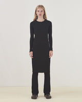 Form-fitted dress in a soft quality. Oasis dress has elegant long sleeves, a round neck, and a length that cuts just below the knee. Edges are ruffled for a beautiful finish.