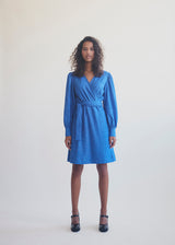 Short dress with wrap detail, tiebelt at the waist, and v-neckline. TalissaMD wrap dress has long puffsleeves with cuff. Designed in a structured material.