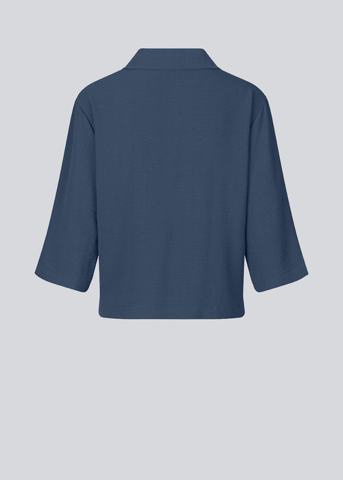 Shirt in dark blue in a relaxed silhouette and 3/4 length sleeves. AaliyahMD shirt has a resort collar, dropped shoulders and button closure in front.