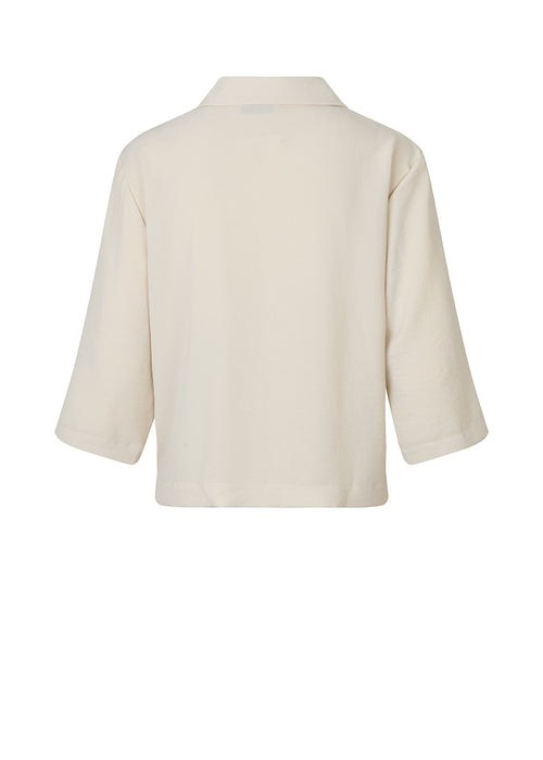 Shirt in beige in a relaxed silhouette and 3/4 length sleeves. AaliyahMD shirt has a resort collar, dropped shoulders and button closure in front.  Material: 100% Polyester