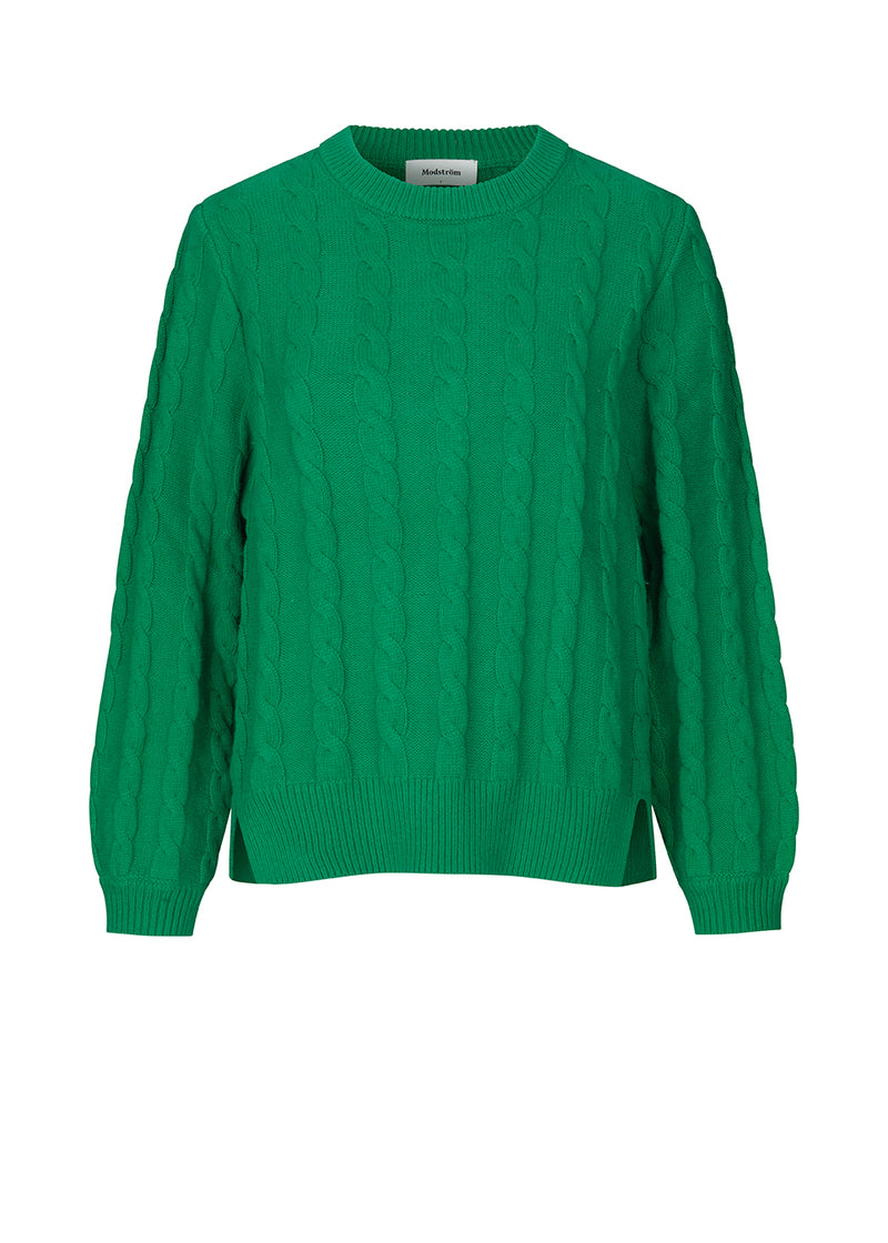 Cable-knitted jumper in green in a soft wool and cotton mix. AliceMD o-neck is designed with a round neck and long sleeves with rib-knit along the neckline, cuffs and hem. The fit is casual.