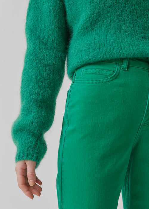 Jeans in green in a dyed organic cotton denim. AmeliaMD jeans have a high waist, five pockets and straight, wide legs. Zip fly and button.