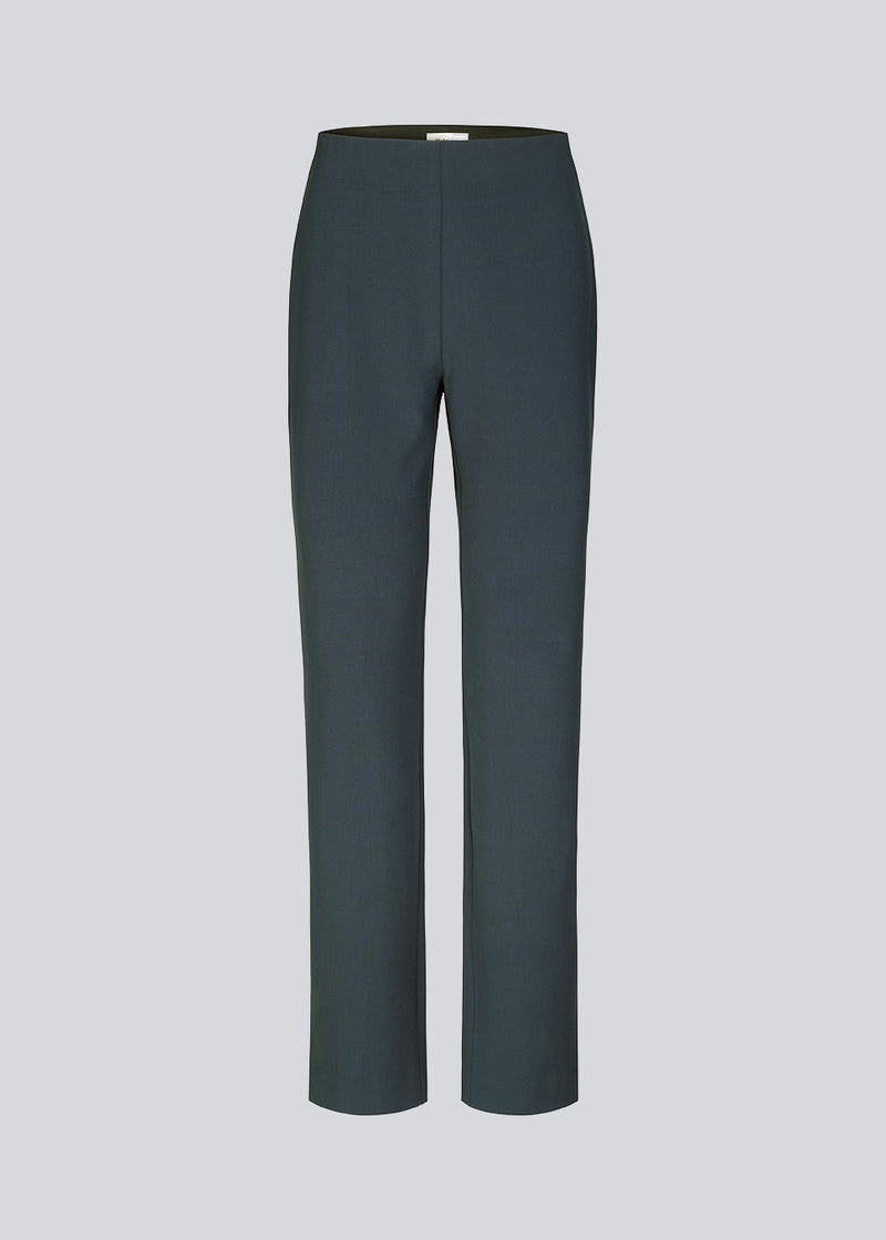 Pants in midnight blue in a slim silhouette with hidden closure at one side. AnkerMD slit pants have decorative paspel back pockets, sewn-in creases, and slits at hems.  Match with: AnkerMD blazer.
