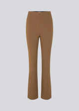 Pants in dark beige in a slim silhouette with hidden closure at one side. AnkerMD slit pants have decorative paspel back pockets, sewn-in creases, and slits at hems.