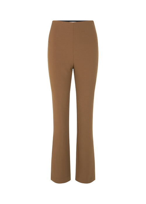 Pants in dark beige in a slim silhouette with hidden closure at one side. AnkerMD slit pants have decorative paspel back pockets, sewn-in creases, and slits at hems.