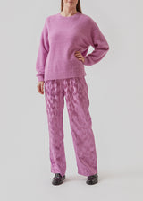 AntMD o-neck in purple has a relaxed fit with dropped shoulders and long sleeves with a tight-fitting, ribbed cuff. Crafted from a soft wool quality.