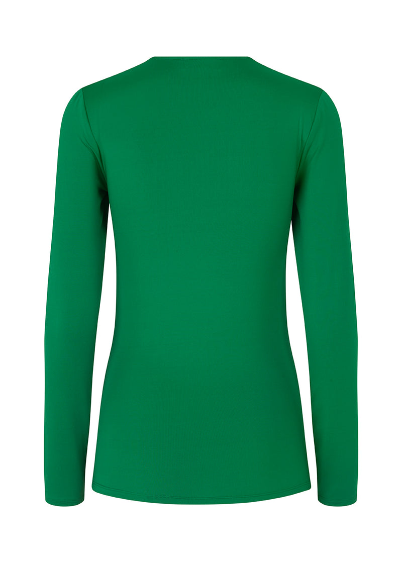 Long sleeved top in green with a formfitted shape and in a stretchy material. ArniMD top has a high v-neckline with a wrap-effect in front.