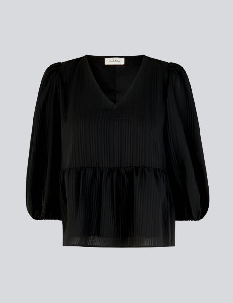 Top in black in a loose silhouette with 3/4 length sleeves, v-shaped neckline and a cutline at the waist for extra volume on the bottom of the top.  Material: 100% Polyester