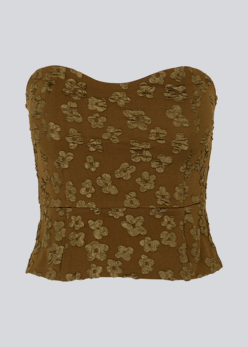 Crop top without sleeves with a heart-shaped neckline and a slight peplum effect. AtiraMD crop top has a structured floral pattern.