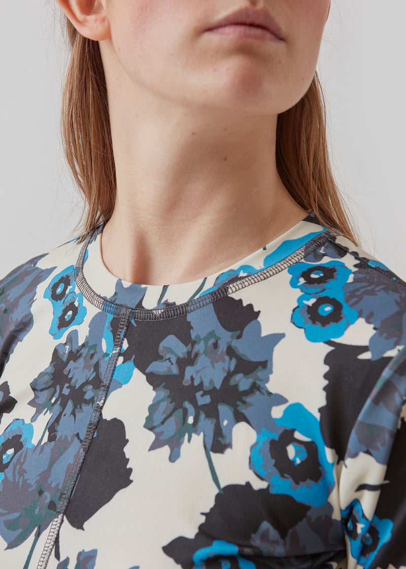 Form-fitting dress with long sleeves and round neck. AustinMD print dress has a decorative vertical stich in front and back.