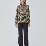 Shirt made from recycled materials. BeckyMD print shirt offers a relaxed fit with wide sleeves with cuff, shirt collar, and button closure in front.