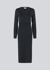 Midi dress in a knitted material with a slim fit. BilgeMD dress has a round neckline, long sleeves, rib-knit detail at the waist, and a slit at one side.