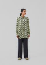 Relaxed, long shirt with a loose-fit silhouette in snake print. CamilaMD print shirt is designed with long sleeves with cuff, collar, and buttons in front.