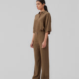Wide-legged pants in the color Dark Forest in a patterned satin. CarmelMD pants have a medium waist with zip-fly, button closure, and elastic in the back for extra comfort. The model is 177 cm and wears a size S/36.  Shop matching shirt: CarmelMD shirt.