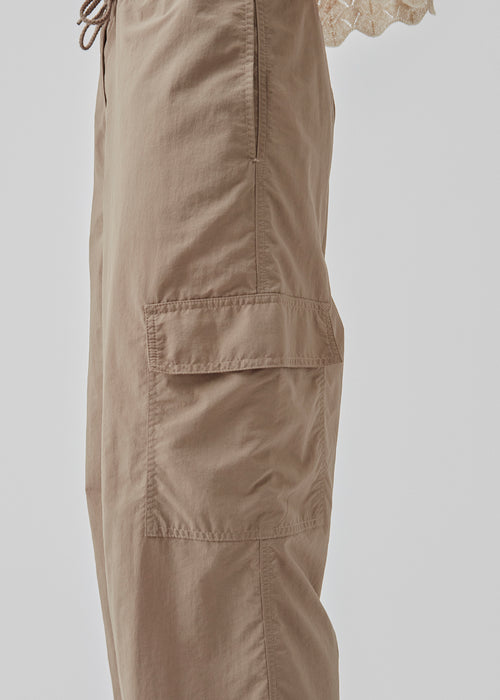 Cargo pants in nylon with straight legs and patch-pockets on the legs. CarmoMD pants has adjustable ties at the waist and hem.