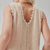Crochet top in beige without sleeves in organic cotton. CaryMD top has detailed trimmings and a deep v-neckline in the back. The model is 177 cm and wears a size S/36.