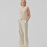 Crochet top in beige without sleeves in organic cotton. CaryMD top has detailed trimmings and a deep v-neckline in the back. The model is 177 cm and wears a size S/36.