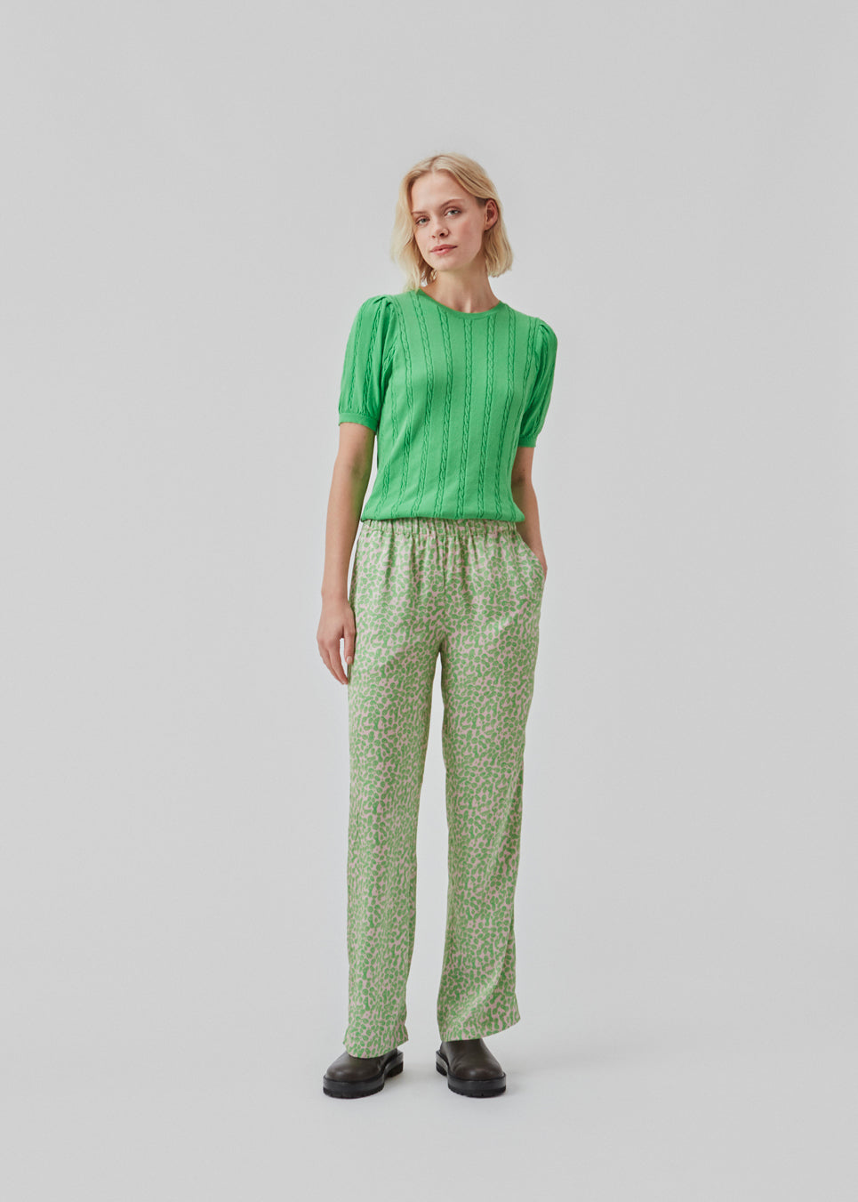 ClarkeMD print pants have straight, wide legs, and a medium waist with covered elasticated. The pants are made from recycled polyester with a smiley print.