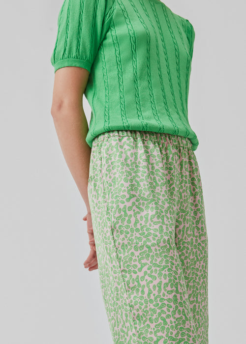 ClarkeMD print pants have straight, wide legs, and a medium waist with covered elasticated. The pants are made from recycled polyester with a smiley print.