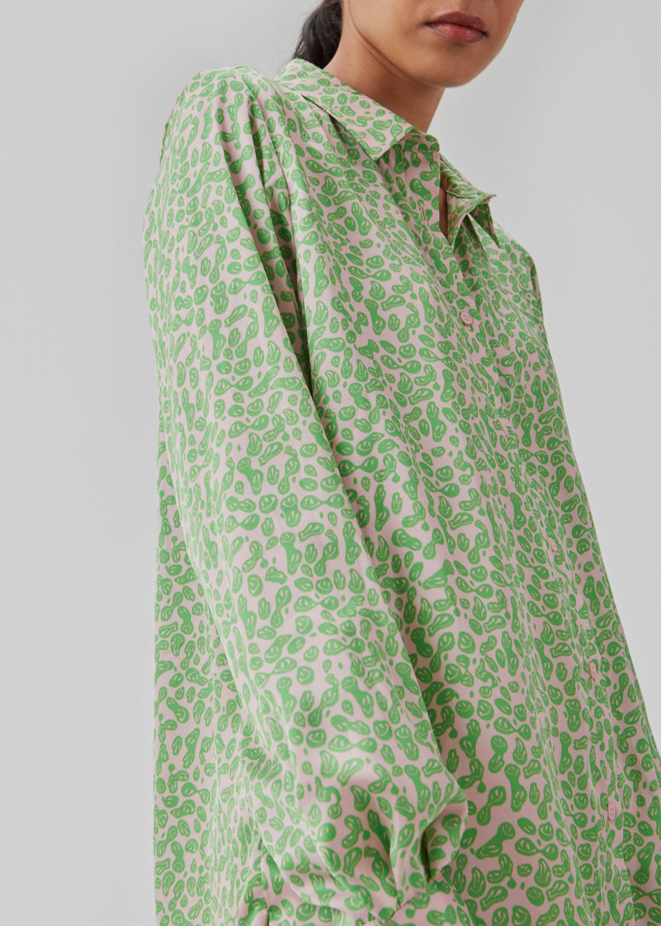Satin shirt with relaxed fit and long sleeves, collar, and buttons in front. ClarkeMD print shirt is cut from recycled polyester with smiley print.