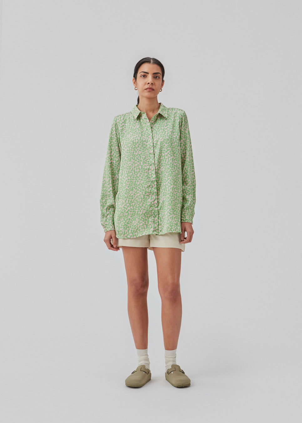 Satin shirt with relaxed fit and long sleeves, collar, and buttons in front. ClarkeMD print shirt is cut from recycled polyester with smiley print.