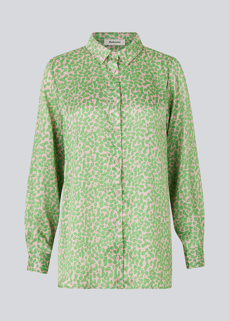 Satin shirt with relaxed fit and long sleeves, collar, and buttons in front. ClarkeMD print shirt is cut from recycled polyester with smiley print.