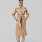 Coat in a shiny material. CollinsMD coat has a classic trenchcoat look with wide collar and lapel, button closure, and belt at the waist.