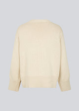 Fine-knitted oversize jumper in beige knitted from cotton. CorbinMD o-neck has ribbed round neckline, long wide sleeves, and wide ribbing at cuffs and hem.