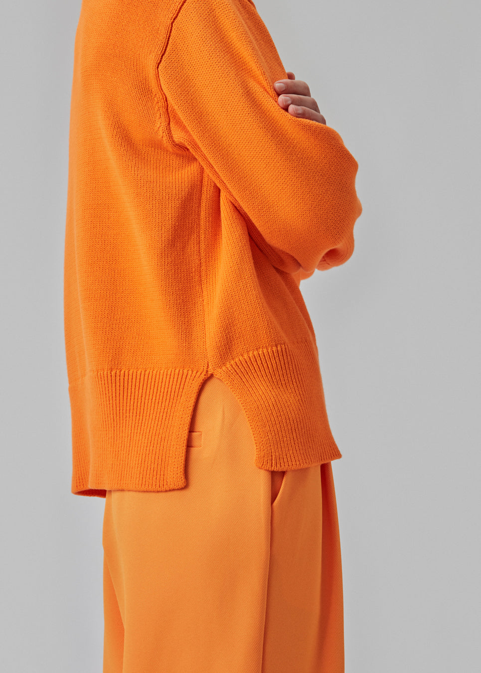 Fine-knitted oversize jumper orange knitted from cotton. CorbinMD o-neck has ribbed round neckline, long wide sleeves, and wide ribbing at cuffs and hem.Fine-knitted oversize jumper orange knitted from cotton. CorbinMD o-neck has ribbed round neckline, long wide sleeves, and wide ribbing at cuffs and hem.