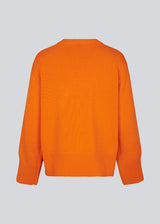 Fine-knitted oversize jumper orange knitted from cotton. CorbinMD o-neck has ribbed round neckline, long wide sleeves, and wide ribbing at cuffs and hem.  The model is 177 cm and wears a size S/36.