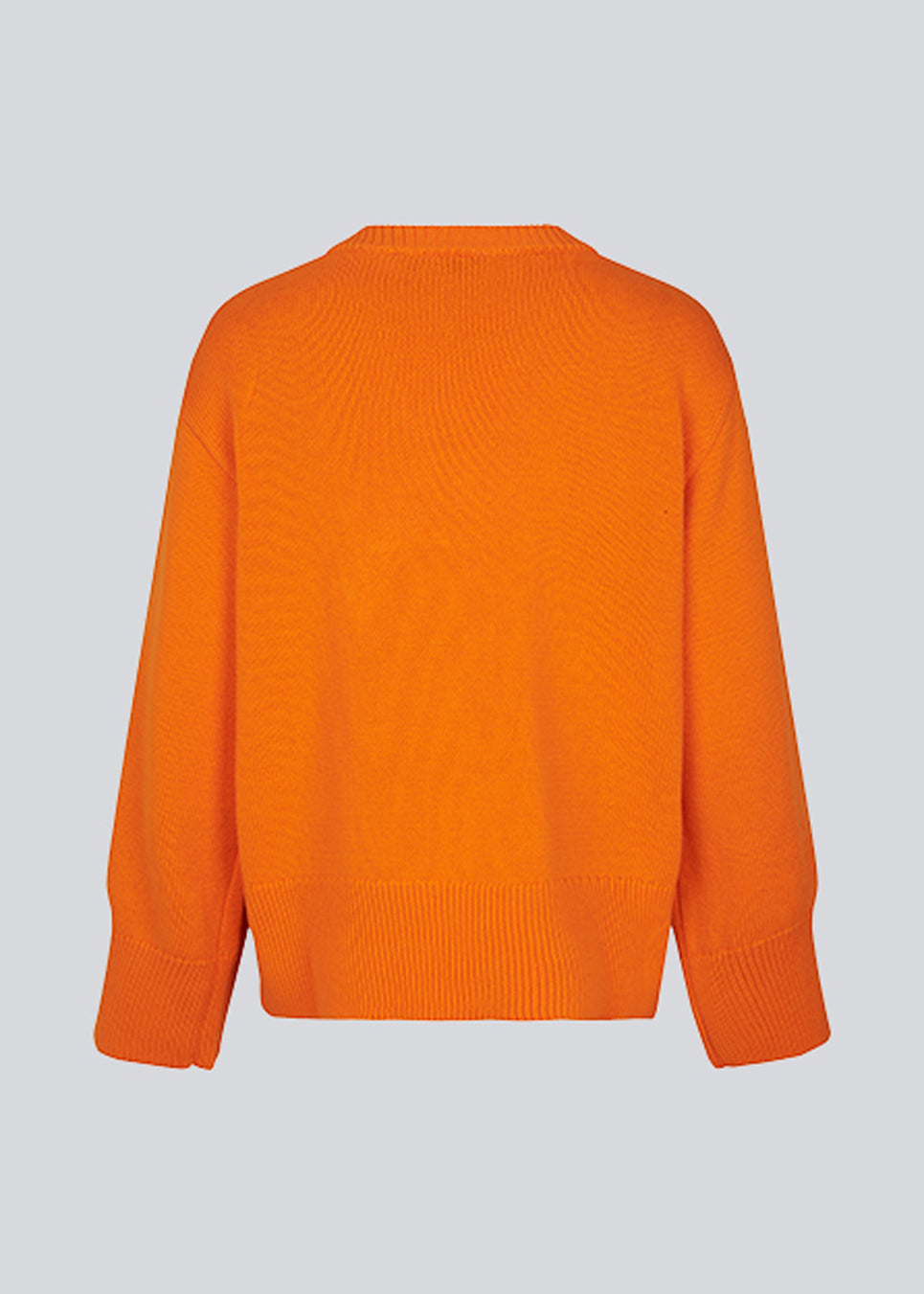 Fine-knitted oversize jumper orange knitted from cotton. CorbinMD o-neck has ribbed round neckline, long wide sleeves, and wide ribbing at cuffs and hem.  The model is 177 cm and wears a size S/36.