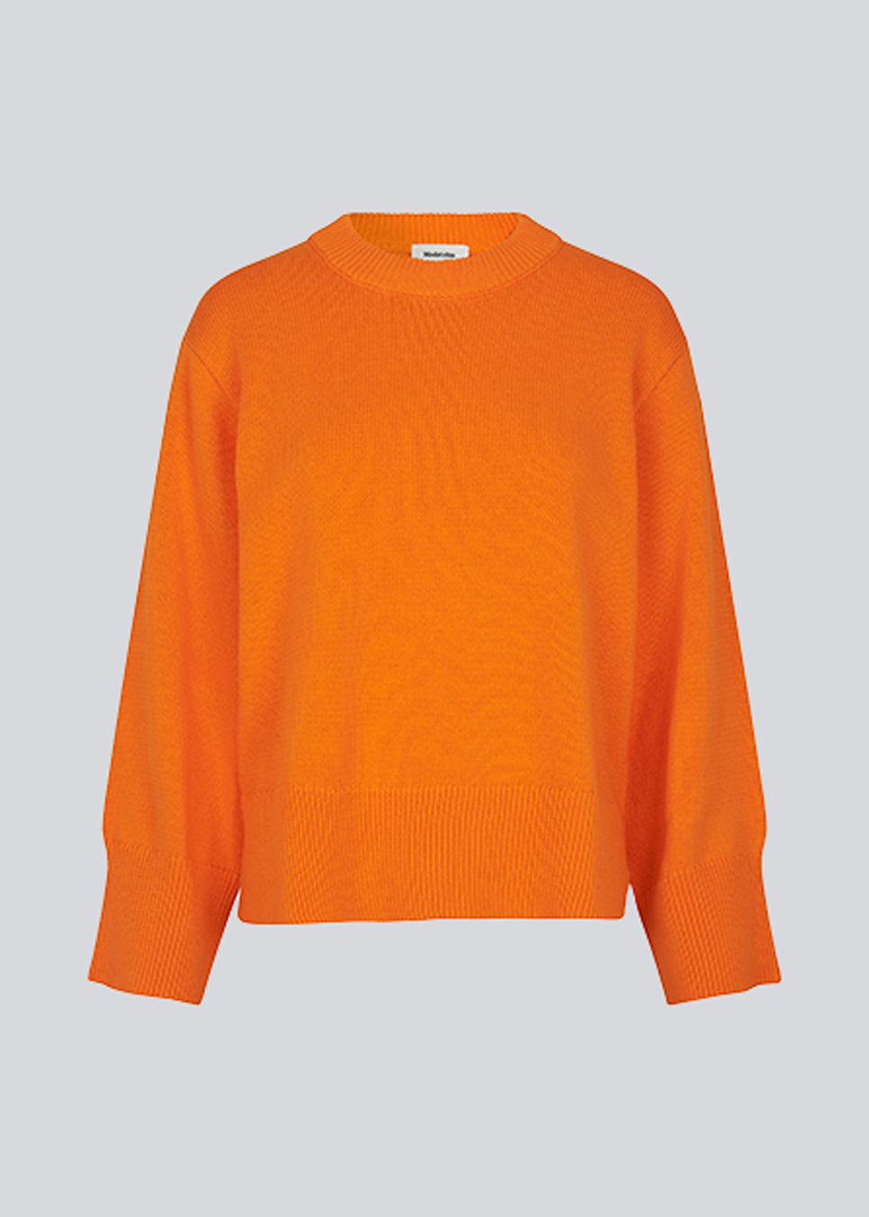 Fine-knitted oversize jumper orange knitted from cotton. CorbinMD o-neck has ribbed round neckline, long wide sleeves, and wide ribbing at cuffs and hem.  The model is 177 cm and wears a size S/36.