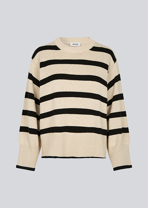 Fine-knitted oversized jumper knitted from cotton with black stripes. CorbinMD stripe o-neck has a ribbed round neckline, long wide sleeves, and wide ribbing at cuffs and hem.