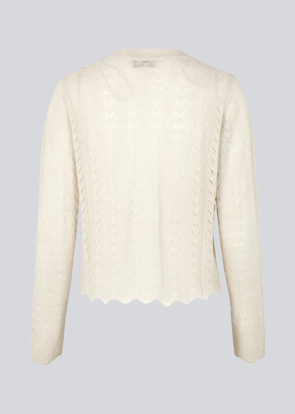 Delicate cardigan in summer sand in wool mix designed with a short length, long sleeves, and a v-neck. CordellMD cardigan has a pattern with holes and a wavy hem.