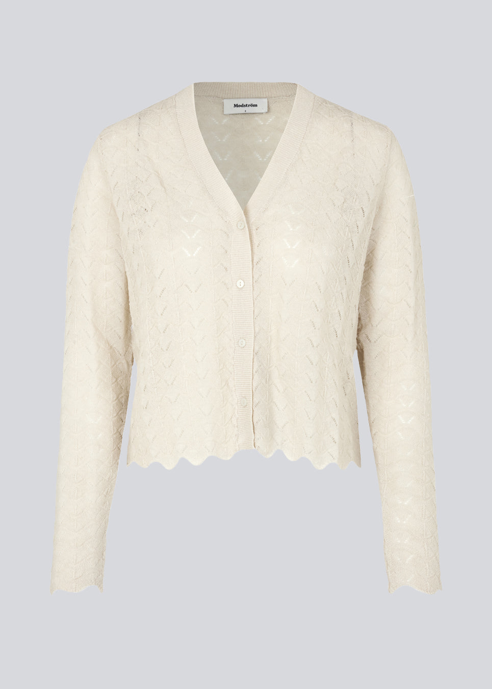 Delicate cardigan in summer sand in wool mix designed with a short length, long sleeves, and a v-neck. CordellMD cardigan has a pattern with holes and a wavy hem.